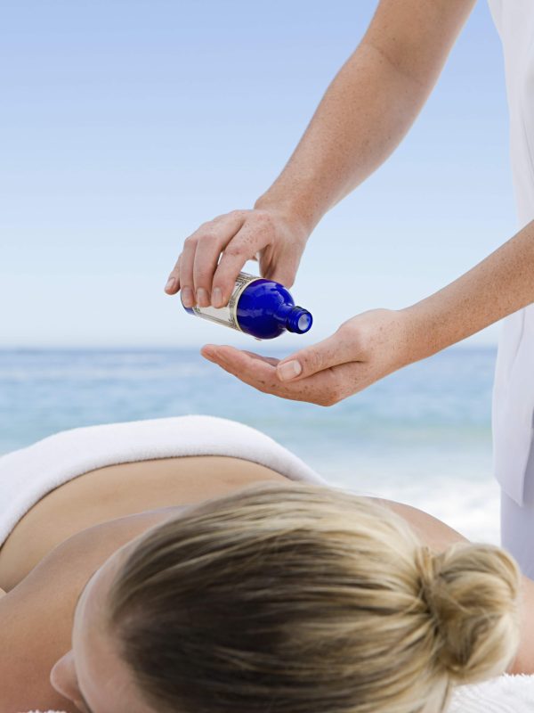The beach. A young woman having a massage.